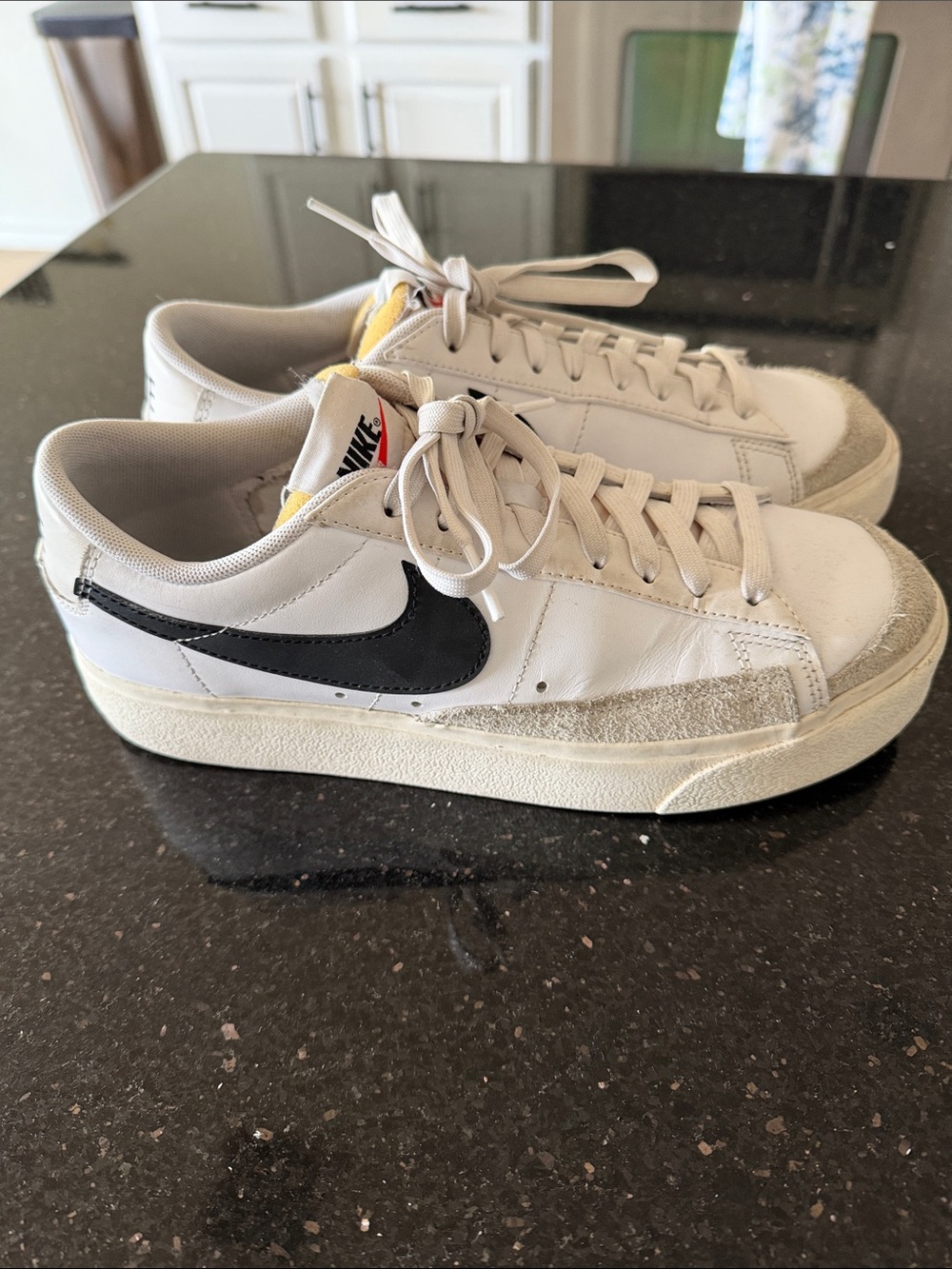 Nike White Leather Low-Top Sneakers with Black Swoosh and Yellow Tongue Accent